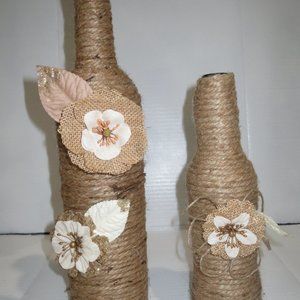 2 Jute wrapped wine bottles/cases. Burlap flowers.